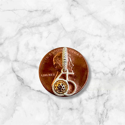 silver pickleball 65 charm with gold ball, on copper penny showing size