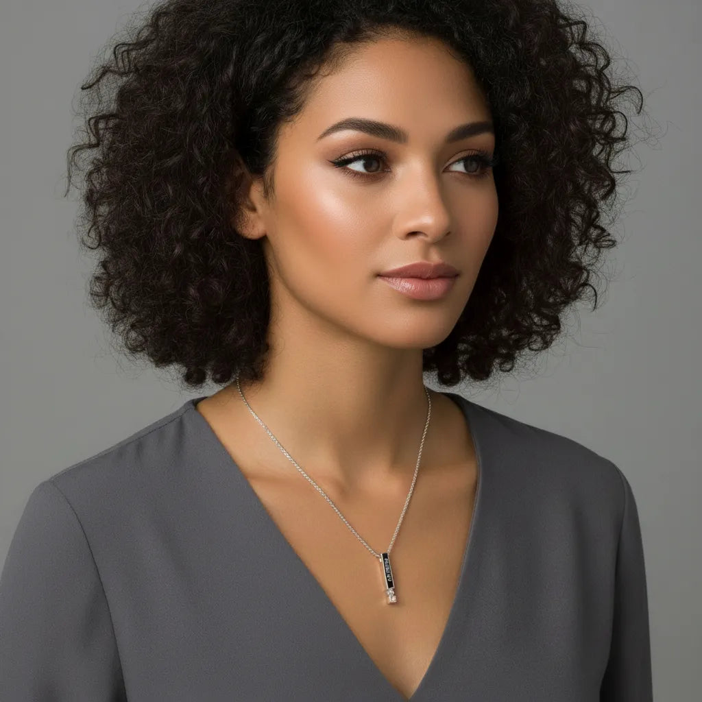 Woman wearing a necklace against a gray background