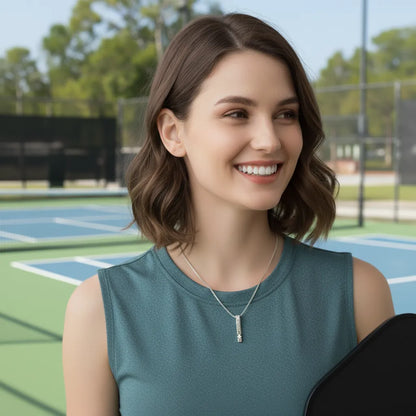 Woman holding a paddle on a pickleball court