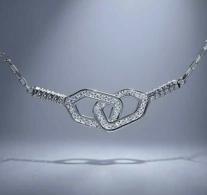 Silver necklace with double pickleball paddles pendant on a gray background