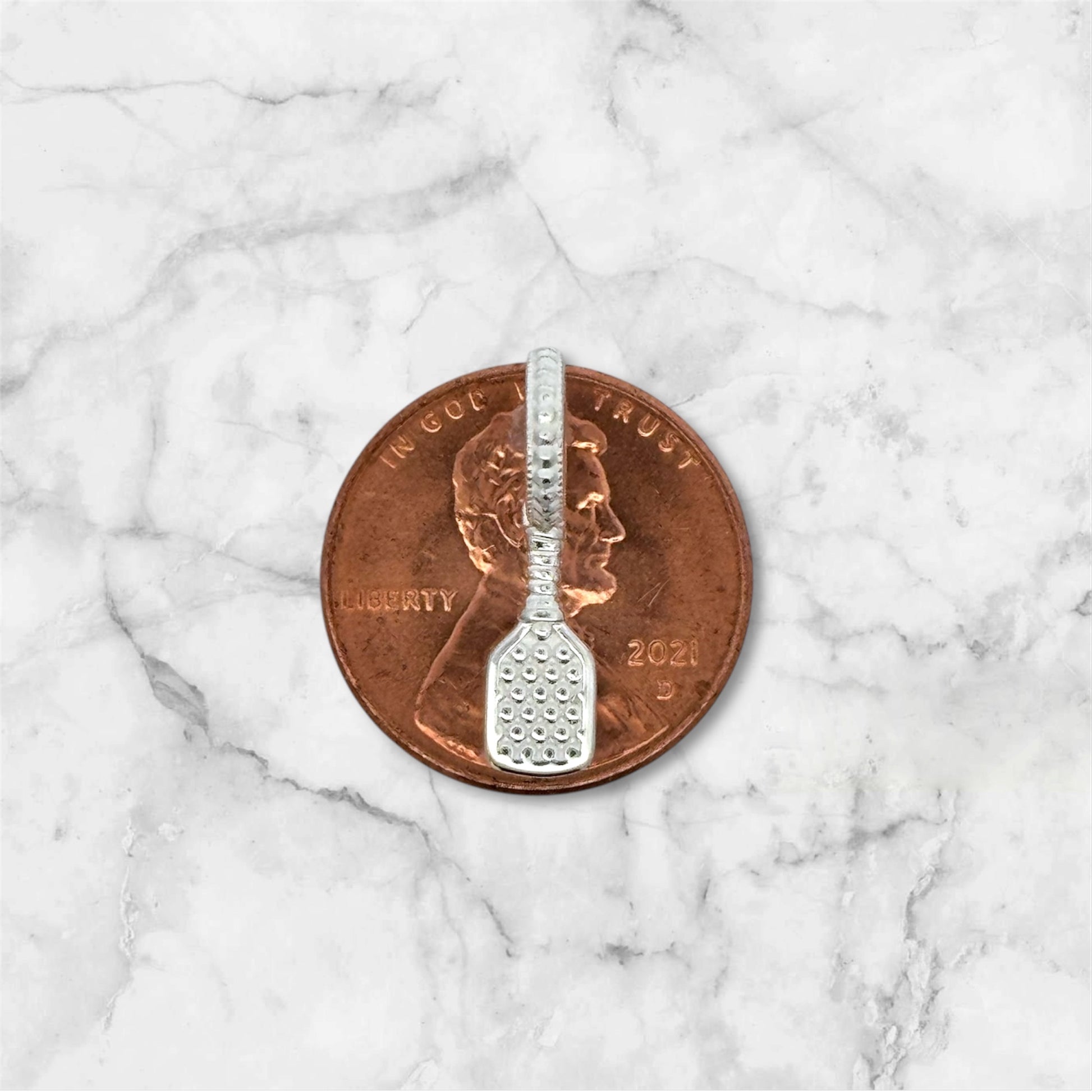 pickleball paddle charm on copper penny to show charm size