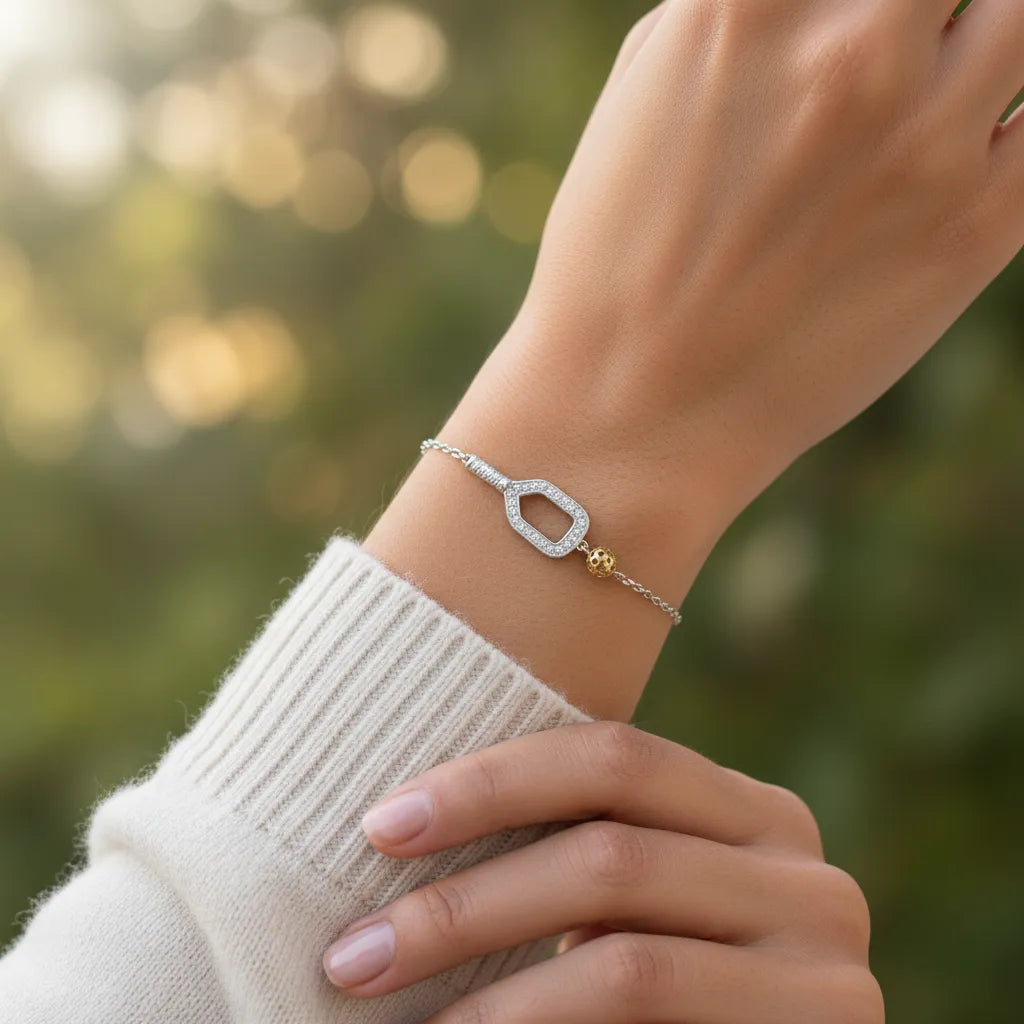 Person wearing a bracelet with a blurred natural background