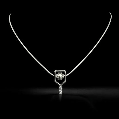 Silver pickleball necklace with a paddle and ball pendant on a black background