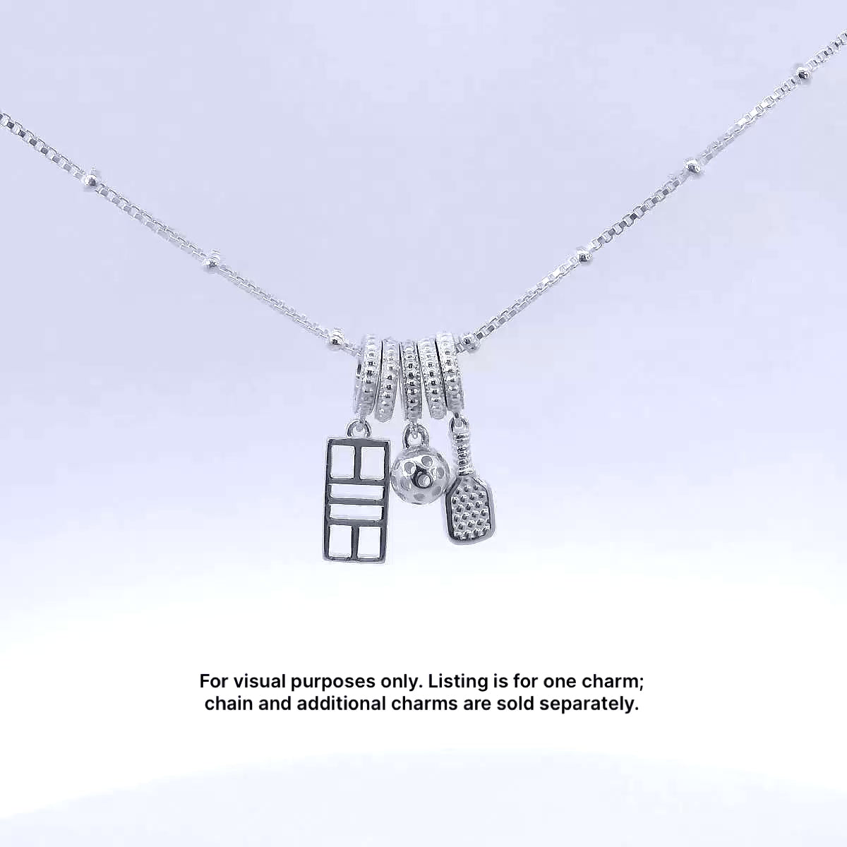 Pickleball paddle, court and ball charms on silver chain.